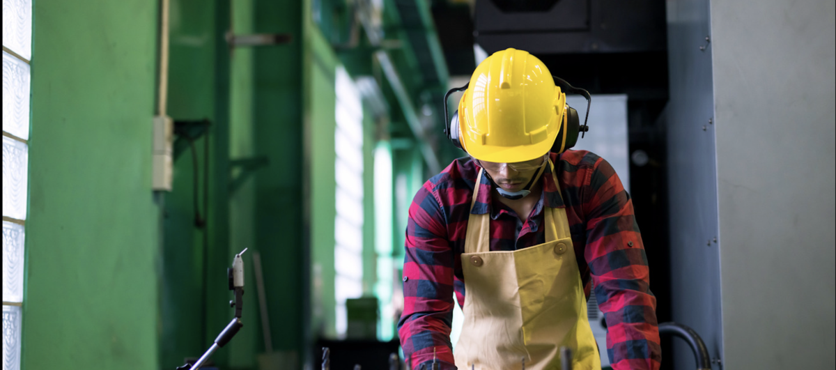 A worker prioritizing workplace safety tips while at work.